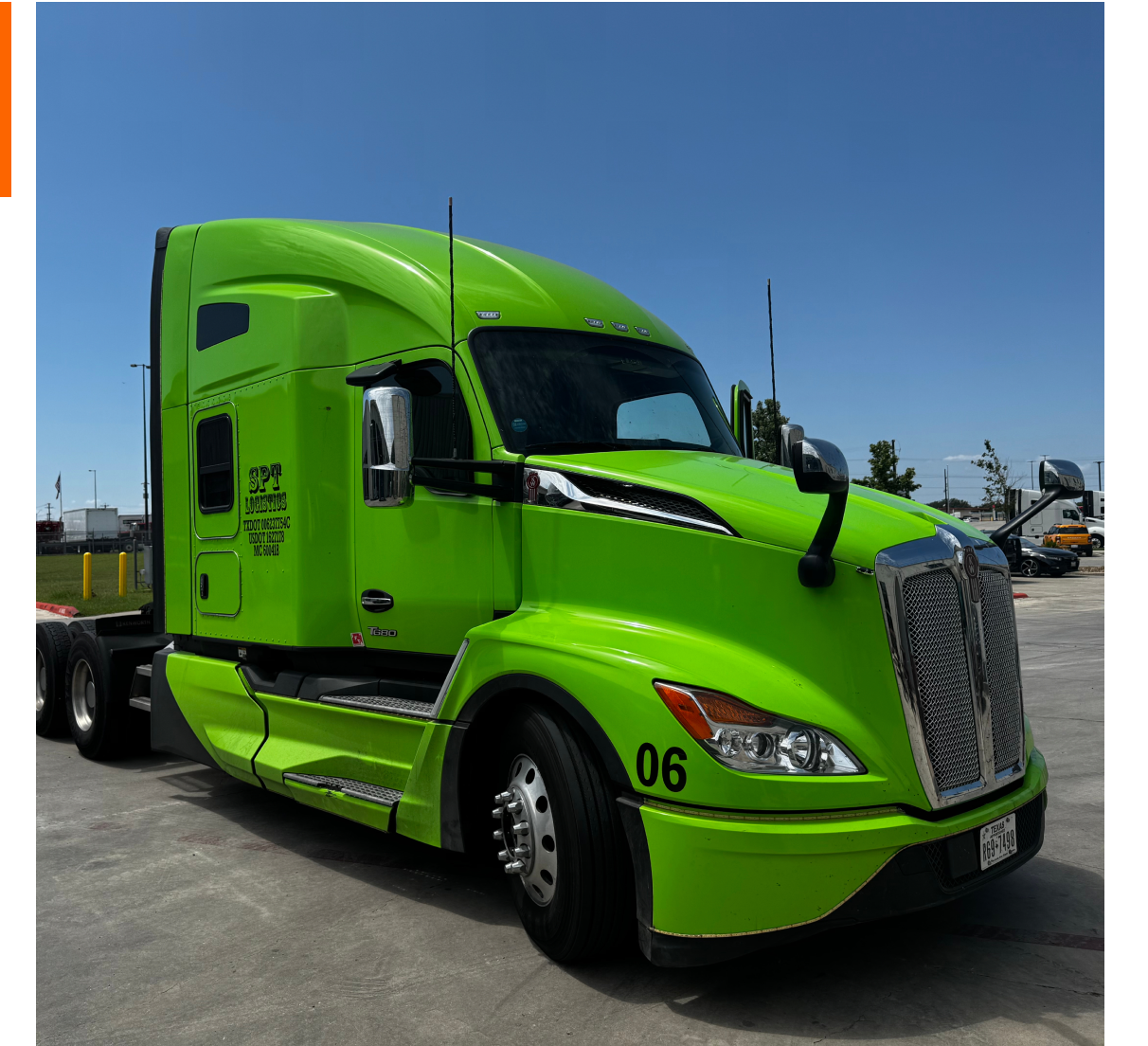 Lime green truck in industrial area.